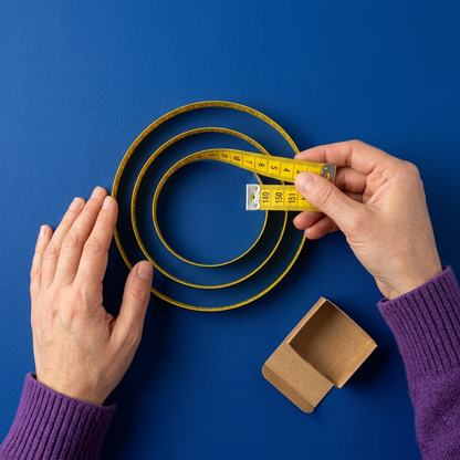 Hands arranging a loose coil beside plain packaging