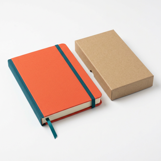 Coral notebook with teal details and plain kraft packaging on white